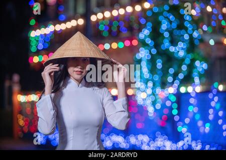 Schöne Frau mit Ao Dai vietnamesischem traditionellen Kleid und Tourist im Stil des alten Hauses Frankreich beim Weihnachtsfest von Sakon Nakhon, Theil Stockfoto