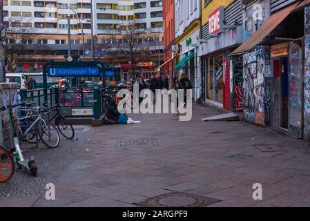 Alltagsszene am Kottbusser Tor in Berlin, Einfahrt zum U-Bahnhof Kottbusser Tor, ein Bettler, viele Menschen, Berlin-Kreuzberg Stockfoto