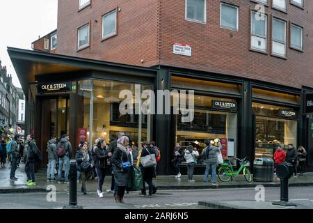 London/Großbritannien - 24. November 2019: Menschen, die an der Bäckerei Ole & Steen auf der Charing Cross Road in London, Großbritannien vorbeilaufen. OLE & Steen Lagkagehuset ist ein dänisches B. Stockfoto