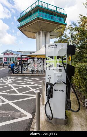 Elektrische Ladestelle für Autos im Autobahngebiet, England, Großbritannien Stockfoto