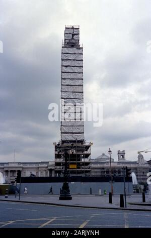 AJAXNETPHOTO. 1987. LONDON, ENGLAND. - NELSONS SÄULE - KULTIGE, VON GERÜSTEN VERSTECKTE, TRAFALGAR-QUADRATSÄULE, DIE EINEM SAUBEREN UNTERSTRICH UNTERZIEHT.FOTO: JONATHAN EASTLAND/AJAX REF:1987RSE33A001 Stockfoto