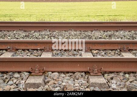 Schienen mit Betonschwellen, seitlich Rost Stockfoto