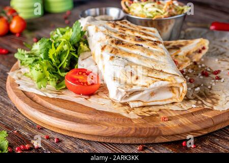 Gegrilltes Veggie-Shawarma serviert mit Coleslaw auf einem Holzbrett, Restaurantgericht, Horizontaler Ausrichtung Stockfoto