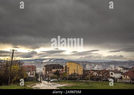 Panoramablick auf Prishtina, die Hauptstadt des Kosovo, von der Velania-Schanze aus bei einem bewölkten regnerischen Nachmittag im Herbst. Bild des dow Stockfoto
