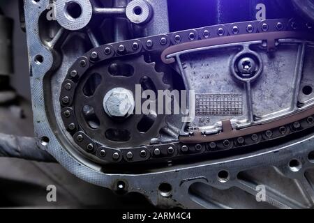 Getriebe, Kettenantriebswelle im Förderband, Band ist in der Produktion. Steuerkette des Fahrzeugs, Spanner im Motor. Industrielle Rollenkette, Technologie mit s. Stockfoto