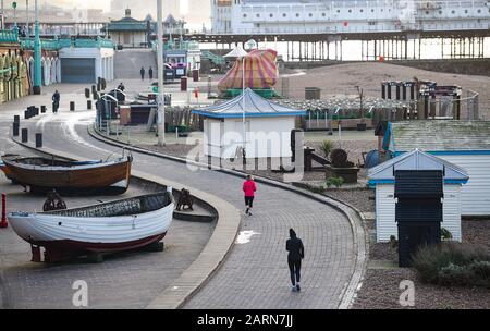 Brighton UK 29. Januar 2020 - Läufer passieren Brighton's Angelviertel an der Küste an einem kühlen, hellen Morgen, da wärmere, aber nasse Witterungsbedingungen für die nächsten Tage über das Land zurückkehren werden. Kredit: Simon Dack / Alamy Live News Stockfoto