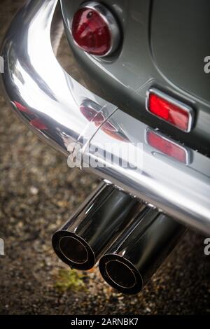 Close up vertikale Bild der roten Rückleuchte und Auspuffrohre eines weißen klassische Oldtimer. Stockfoto