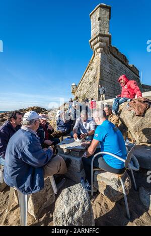 Gruppe von Männern spielt Karten neben Fort Sao Francisco Queijo (allgemein bekannt als Burg von Käse) in Nevogilde Zivilgemeinde von Porto, Portugal Stockfoto