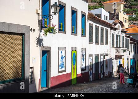 Wandgemälde in den Hinterstraßen von Camara de Lobos auf Madeira mit den Etiketten von Getränkebehältern, einigen amüsanten und einigen berühmten Gesichtern Stockfoto