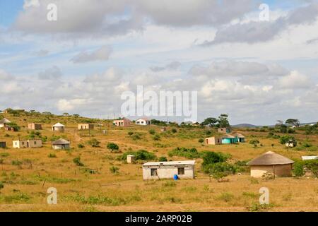 Wohnhäuser im Dorf an der Straße zwischen St. Lucia und Imfolozi-Hluhluwe National Park, KwaZulu Natal, Südafrika. Stockfoto