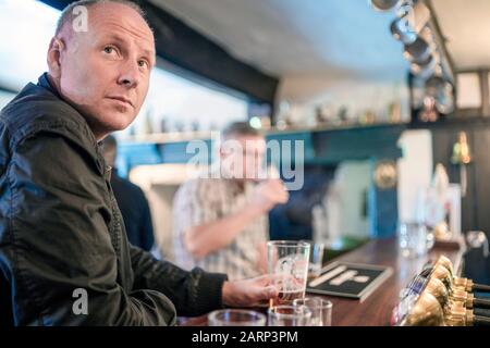 Der Mann genießt sein Bier im britischen Pub, Großbritannien Stockfoto