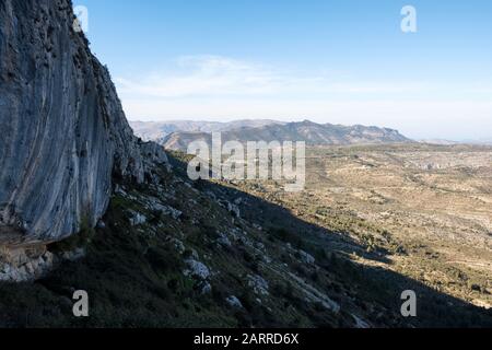 Berge der Sierra del Ferrer und Kalkfelsen von PR-CV7 Fußweg (Sierra de Bernia, Marina Alta, Alicante, Valencianische Gemeinschaft, Spanien) Stockfoto