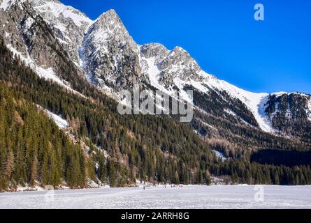 Hohe Gipfel überblicken die gefrorene Oberfläche des Anterselva-Sees Stockfoto