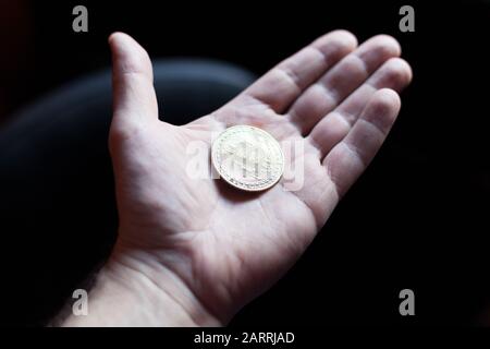 Halten einer Bitcoin-Kryptokurrency in der Hand Stockfoto