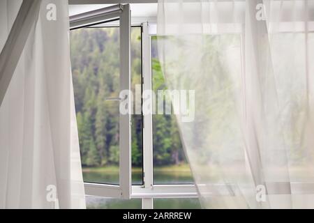 Blick auf schönen Wald durch großes Metall-Kunststoff-Fenster Stockfoto