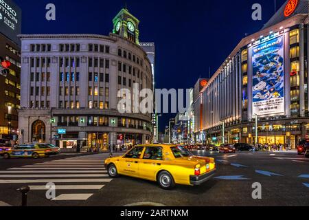 Tokio, Japan, August 2019 - EIN gelbes Taxi vor dem Kaufhaus Ginza Wako Stockfoto