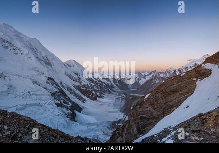 Morgenblick auf die Laila Peak Range und das Kuispang Camp auf der Spitze von Gondogoro La mit dem Biarchedi Peak auf der rechten Seite, Pakistan Stockfoto