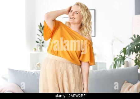 Glückliche Frau mit reifem Körper zu Hause Stockfoto