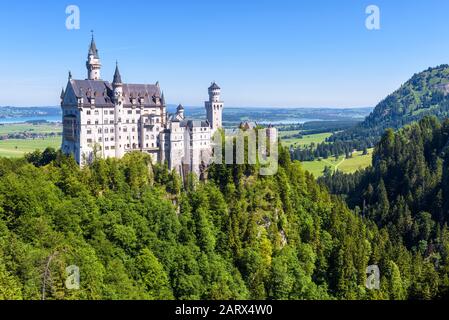 Schloss Neuschwanstein bei Füssen, Bayern, Deutschland. Diese Königliche Burg ist ein berühmtes Wahrzeichen Deutschlands. Schöne Landschaft mit Bergen und Fairyta Stockfoto