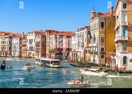 Venedig, Italien - 21. Mai 2017: Sonnige Aussicht auf den Canal Grande mit Touristenbooten in Venedig. Der Canal Grande ist eine der Hauptattraktionen Venedigs. Stockfoto