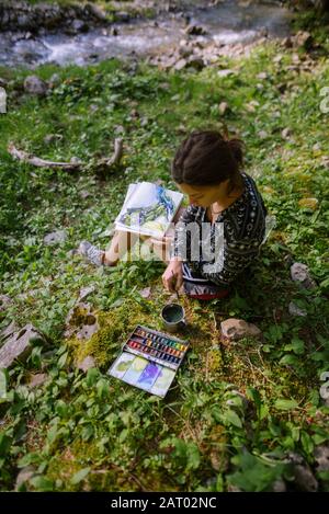 Frau mit Aquarellen am Fluss in Appenzell, Schweiz Stockfoto