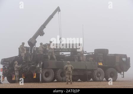 US-Soldaten, zugeordnet zum 1st Battalion, 6th Field Artillery Regiment, 41st Field Artillery Brigade, entladen M270A1 Multiple Launch Rocket System Raketenpod Container während einer Live-Feuer-Übung im Grafenwoehr Training Area des 7th Army Training Command, Grafenwoehr, Deutschland, 27. Januar 2020. Dies ist die erste Live-Feuer-Übung einer europäischen MLRS-Einheit der US-Armee seit 2004. (USA Armeefoto von Markus Rauchenberger) Stockfoto