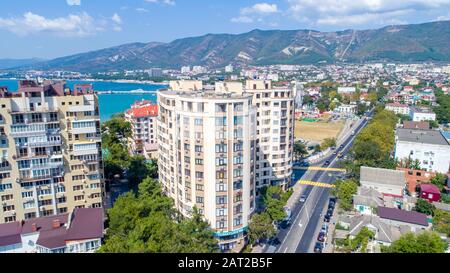 Mehrstöckige Wohnhäuser am Ufer der Gelendzhik Bay. Luftansicht. Sichtbares Meer, Berge, Strand. Erholungsort Leben in der Stadt Stockfoto