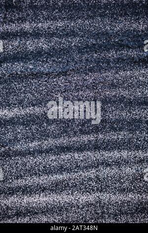 Bemalte Putzwand mit schwarzer Farbe. Vertikal. Textur. Hintergrund Stockfoto