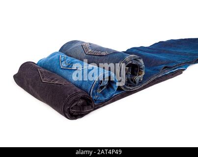 Drei gerollte Jeans aus Denim, isoliert auf Weiß Stockfoto