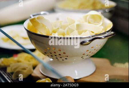 Schüssel mit frischen, ungekochten Fettuccin oder Tagliatelle italienische traditionelle Pasta Stockfoto