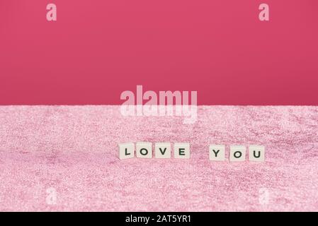 Cubes with love you letting on velour pink cloth isolated on pink, girlish concept Stockfoto