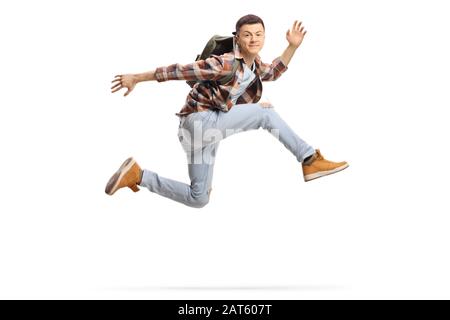 Student springt hoch und lächelt isoliert auf weißem Hintergrund Stockfoto