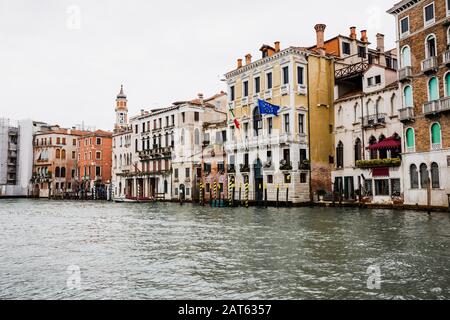 Canal und alte Gebäude mit Flaggen in Venedig, Italien Stockfoto
