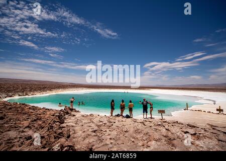 Touristen, die das salzige Wasser der Lagunas Escondidas de Baltinachi, Atacama-Wüste, Antofagasta, Chile, genießen Stockfoto