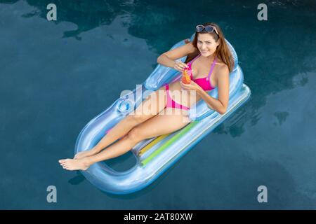 Junge Frau Entspannung im Schwimmbad Stockfoto