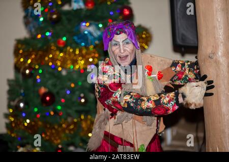 Baba Yaga auf dem Hintergrund des Weihnachtsbaums. Stockfoto