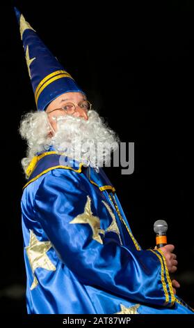 Ein Mann in einem Zauberer-Kostüm mit Mikrofon. Astrologer. Stockfoto