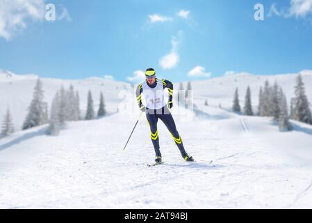 Nordische Skifahrerin auf dem Querfeldeinrennen in Laufposition Stockfoto