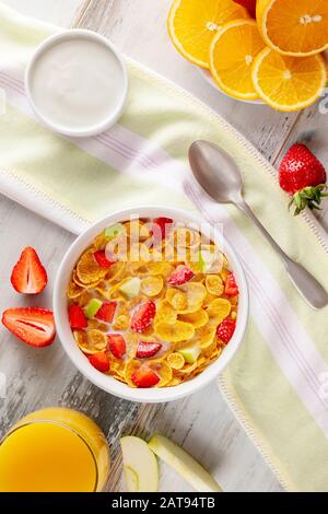 Gesundes Frühstück Cornflakes und Erdbeeren mit Milch, Joghurt und Orangensaft. Bio gesund. Nahaufnahme Stockfoto
