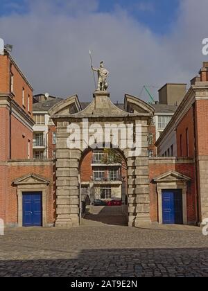 Arch Gate zum Dubliner Schloss mit einer Statue der Stärke an einem sonnigen Tag Stockfoto