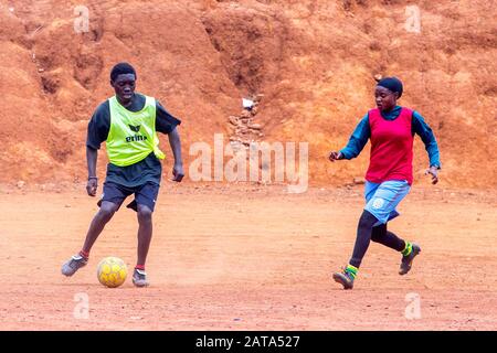 Mädchen, die auf einem Spielplatz gegenüber dem Centre Culturel Islamique Nyamirambo (Kwa kadhafi) in Kigali, Ruanda Fußball spielen. Stockfoto