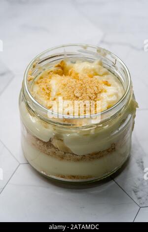 Hausgemachter Pudding Banana mit Baby-Keks-Pulver. Türkische Magnolia Dessert in Glass Bowl. Organisch Gesundes Dessert. Stockfoto