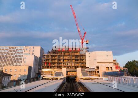 Baustelle mit lupendem Jib-Turmkran bei der Arbeit / an dem, was der Twickenham Gateway Hauptbahnhof sein wird, bestehend aus Wohnimmobilienunterkünften und Einzelhandelsgeschäften. London. GROSSBRITANNIEN. (112) Stockfoto