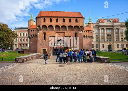 Krakow, Polen - 23. September 2019: Gruppe von Touristen auf geführten Besichtigungstouren im Barbakan Krakowski (Polnisch: Barbakan Krakowski), im Stil der Gotik Stockfoto