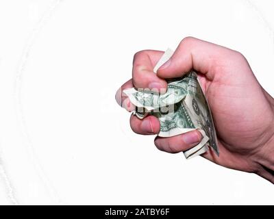 Die Hand hält und drückt die Dollar. Stockfoto