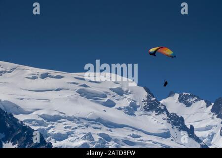 Gleitschirmflieger suchen Thermik unter den Schneekappen des Monte-Blanc-Massivs, Chamonix, Frankreich Stockfoto