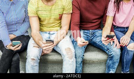 Eine Gruppe von Studenten, die Smartphones in der Hochschulpause beobachten - Junge Leute suchen nach neuen Technologietrends - Entfremdungsmoment für neue Gener Stockfoto