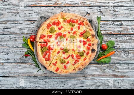 Pizza mit Pesto und Paprika. Italienische Küche. Auf Holzgrund. Freier Speicherplatz für Text. Draufsicht. Stockfoto