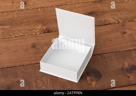 Leere weiße flache quadratische Geschenkbox mit geöffnetem Klappdeckel auf dunklem Holzhintergrund. Beschneidungspfad um das Rahmenmodell herum Stockfoto
