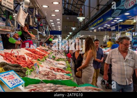 Menschen, die Fisch und Meeresfrüchte in der Markthalle Mercat de l'Olivar auf Palma Mallorca kaufen Stockfoto